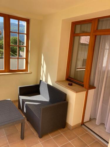 a living room with a chair and a window at Ústí nad Labem, Apartmány pod hradem Střekovem in Ústí nad Labem