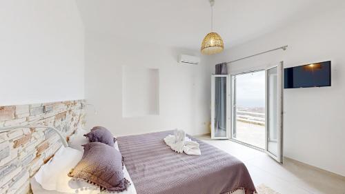 Posteľ alebo postele v izbe v ubytovaní Mykonian Tramonti Villas