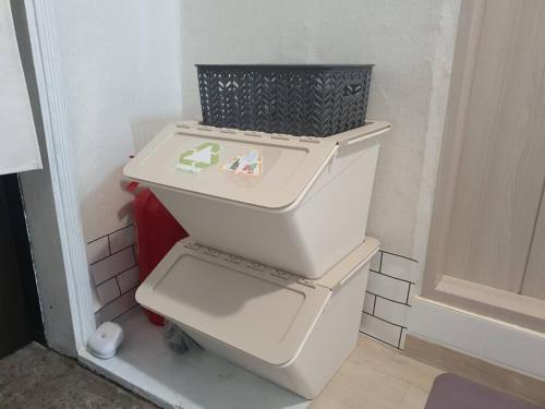a white toilet with a basket on top of it at Seoul House in Seoul