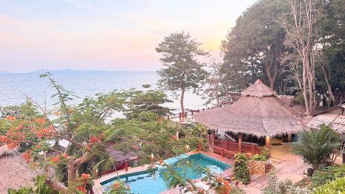a resort with a swimming pool next to the ocean at Koh Jum Resort in Ko Jum