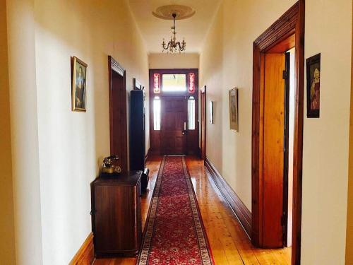 a hallway of a home with a door and a rug at Kimbell Hill Yarra Valley in Wandin East