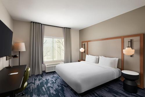a hotel room with a large white bed and a window at Fairfield by Marriott Inn & Suites Austin Georgetown in Georgetown