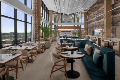 a restaurant with couches and tables and windows at The Westin Atlanta Gwinnett in Duluth