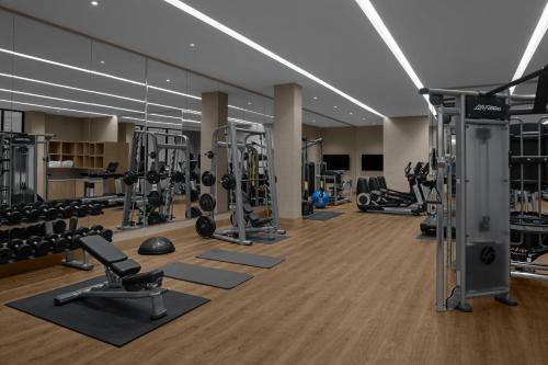 a gym with lots of treadmills and weights at The Westin Atlanta Gwinnett in Duluth