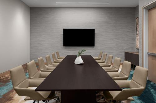 a conference room with a black table and chairs at The Westin Atlanta Gwinnett in Duluth