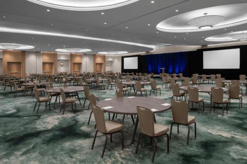 a conference room with tables and chairs and screens at The Westin Atlanta Gwinnett in Duluth
