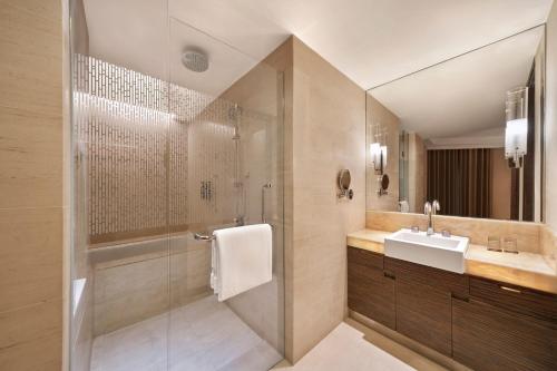 a bathroom with a shower and a sink at Sheraton Nha Trang Hotel & Spa in Nha Trang