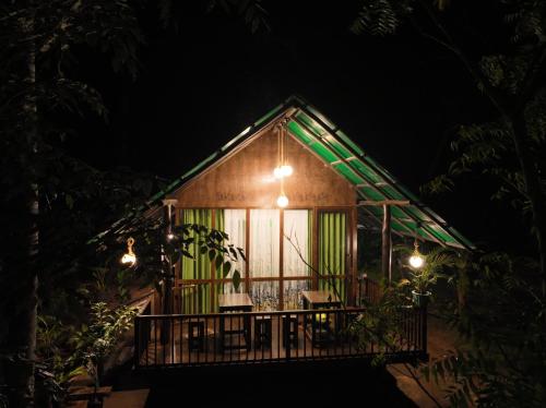a small house with a balcony at night at Nature World Udawalawe in Udawalawe