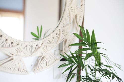 a mirror with a plant in front of it at ONJUKU BEACH COTTAGE - private house 1 min walk to beach in Onjuku