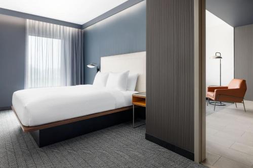 a bedroom with a bed and a desk and a chair at Courtyard by Marriott New Castle in New Castle