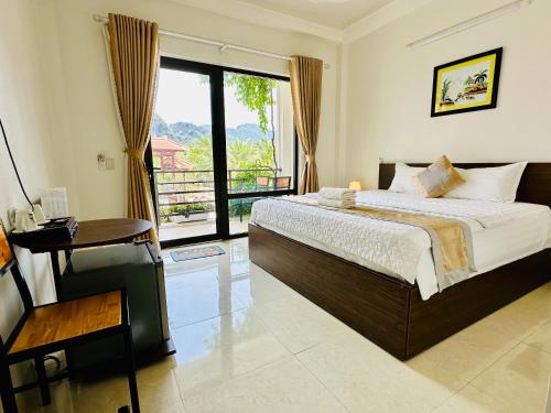 a bedroom with a bed and a large window at Tam Coc Elegance House in Ninh Binh