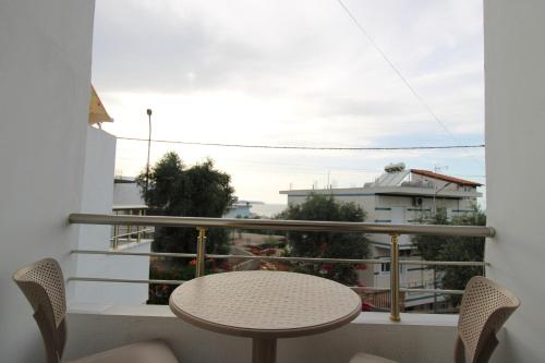 a balcony with a table and chairs and a view at Garden Vila Ermali in Ksamil