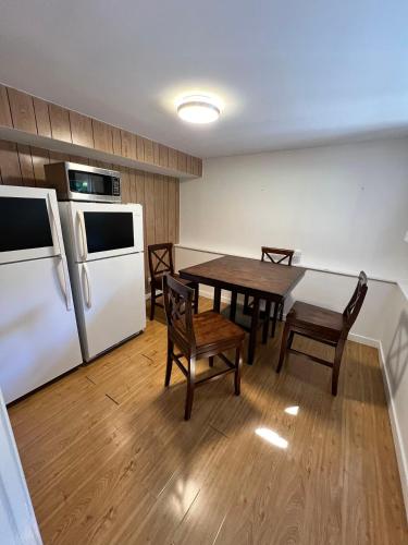 a kitchen with a table and a white refrigerator at Green House in Vancouver West in Vancouver