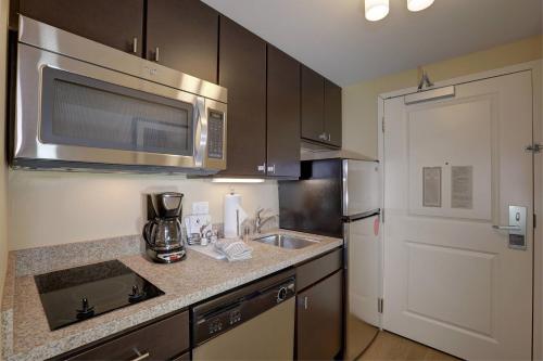 a kitchen with a sink and a microwave at TownePlace Suites Richland Columbia Point in Richland
