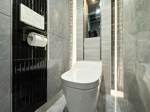 a bathroom with a white toilet and a shower at Hotel Century in Chiba
