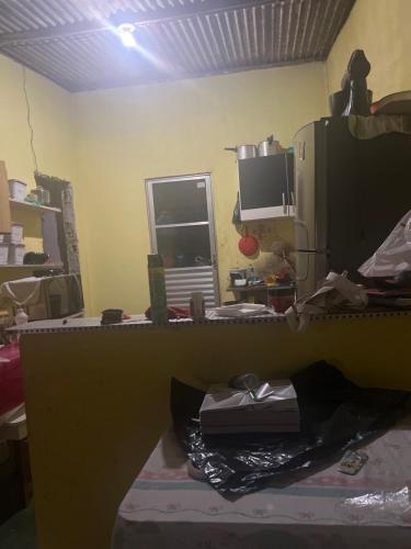 a room with a desk with a computer and a window at Grande família in Salvador