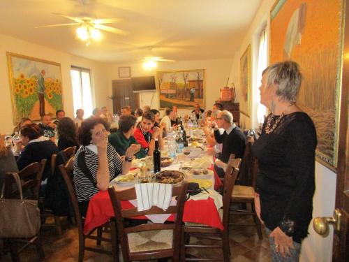 a group of people sitting at a long table at Agriturismo Rocca Dei Marchesi in Sabbio Chiese