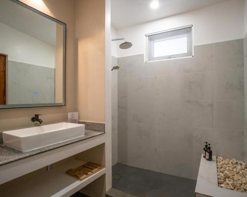 a bathroom with a sink and a mirror at Bathala Resort in Panglao