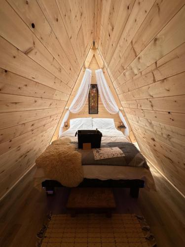 a bedroom with a bed in a wooden room at Bluestone Acres Farm in Vavenby