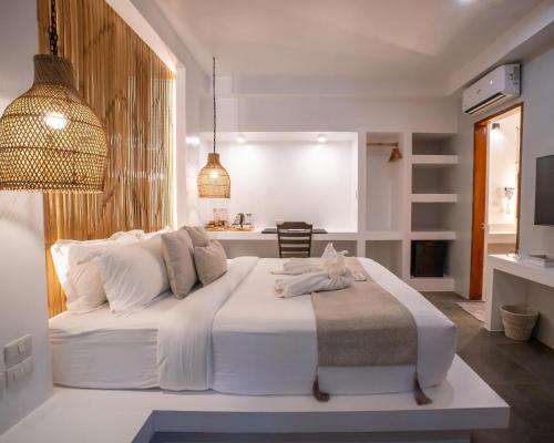 a bedroom with a large white bed in a room at Bathala Resort in Panglao