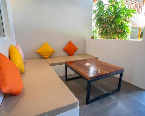 a room with a bench and a table at Bathala Resort in Panglao