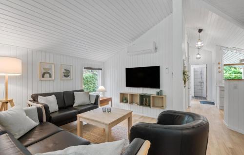 a living room with a couch and a tv at 4 Bedroom Cozy Home In Ansager in Ansager