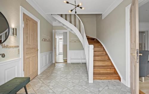 a hallway with a spiral staircase with a stair case at Amazing Home In Skærbæk With Kitchen in Skærbæk