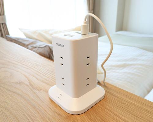 a white object sitting on top of a bed at The Global West in Niihama