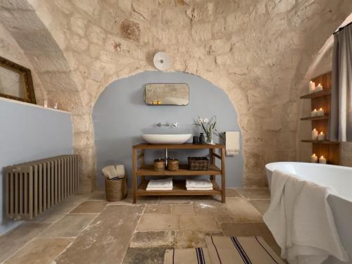 a bathroom with a sink and a bath tub at Masseria Celeste in Fasano
