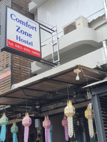 a sign that reads comfort zone hottest hanging from a building at Comfort Zone Hostel @ Tha Pae in Chiang Mai