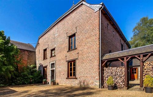 an old brick building with a large window at Amazing Home In Gedinne With Sauna in Gedinne