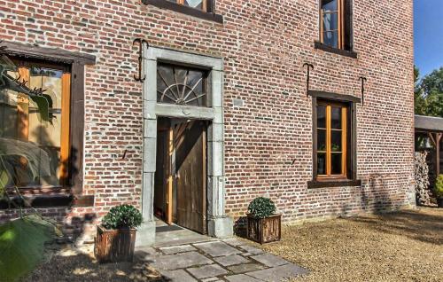 a brick building with a door and two windows at Amazing Home In Gedinne With Sauna in Gedinne