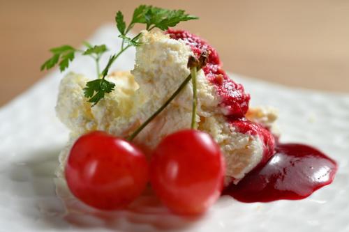 a piece of cake with cherries on a plate at Eirakukan in Koriyama