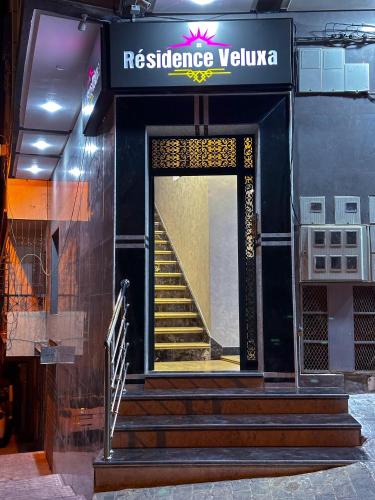 a entrance to a building with stairs and a sign at VELUXA - LUXURY HOLIDAY HOMES - Centric flat in Tangier
