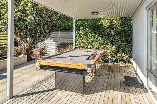 a pool table sitting on top of a deck at Hipango Point in Whanganui