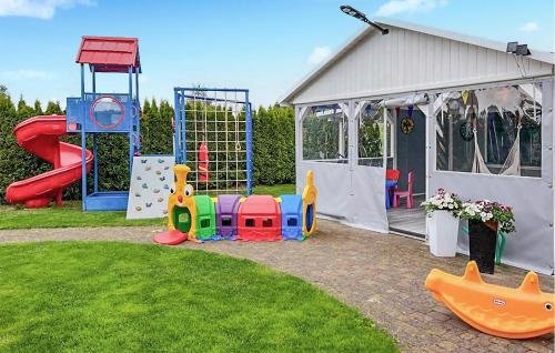 a backyard with a playground and a play structure at 2 Bedroom Gorgeous Home In Chlopy in Chłopy