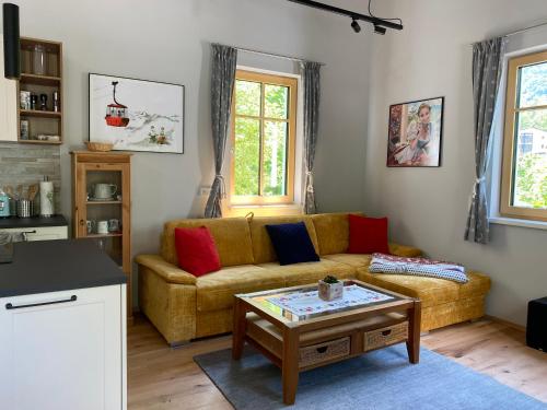 a living room with a couch and a coffee table at Cottage Bad Ischl in Bad Ischl