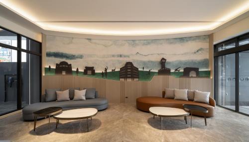 a living room with a couch and two tables at Lihe Jiazhu in Tainan