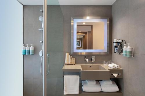 a bathroom with a sink and a shower at Novotel Bangkok on Siam Square in Bangkok