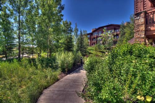 a path in front of a building next to a building at Wasatch Springs 13804 by Moose Management in Park City