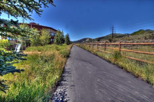 an empty road next to a house in a field at Wasatch Springs 13804 by Moose Management in Park City