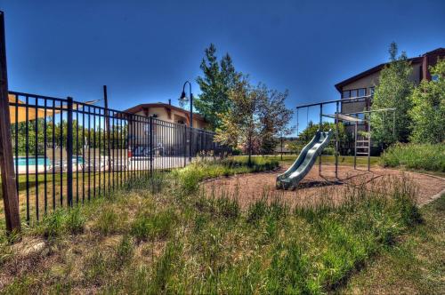 a playground with a slide in a park at Black Rock Ridge 14457 by Moose Management in Kamas