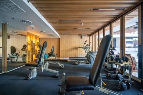 a gym with treadmills and elliptical machines at Arcadia Suites Bangkok in Bangkok