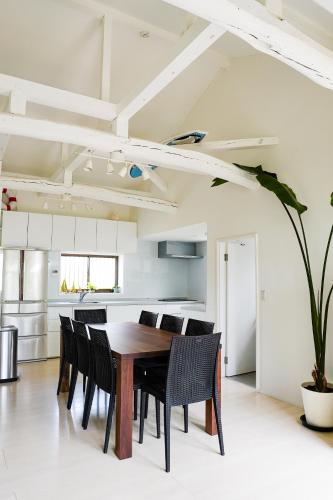 a kitchen and dining room with a table and chairs at ONJUKU BEACH HOUSE - private villa 1 min walk to beach with sea view in Onjuku