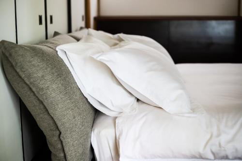 a pile of pillows sitting on top of a bed at ONJUKU BEACH HOUSE - private villa 1 min walk to beach with sea view in Onjuku