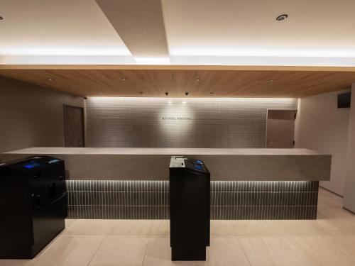 a bathroom with a counter and a cash register at Sunhotel Fukuyama in Fukuyama
