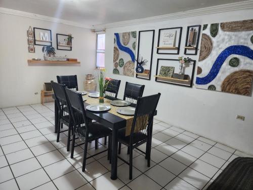 a dining room with a black table and chairs at Casa Morada in San Felipe