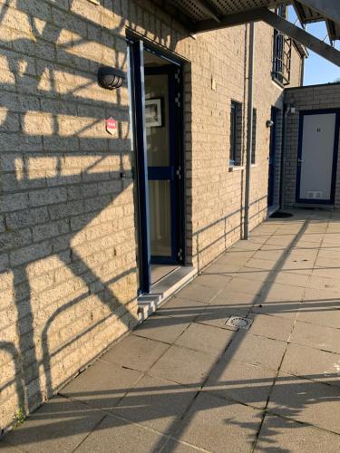 a door on a brick building with a sidewalk at Durbuy Dream in Durbuy