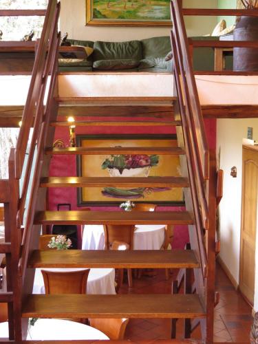 a wooden staircase with a table and a bunk bed at Chalet Campestre la Peseta in Ubaté