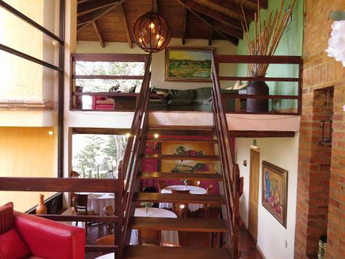 a room with a spiral staircase in a house at Chalet Campestre la Peseta in Ubaté